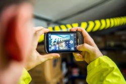 taking a picture of damaged parcel with handheld computer