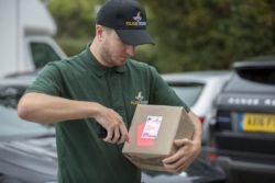 man outside scanning box with smartphone