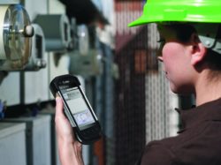 worker in hard hat with handheld mobile computer