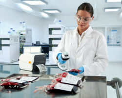 woman using handheld scanner in lab