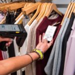 Woman in clothing store scanning tag